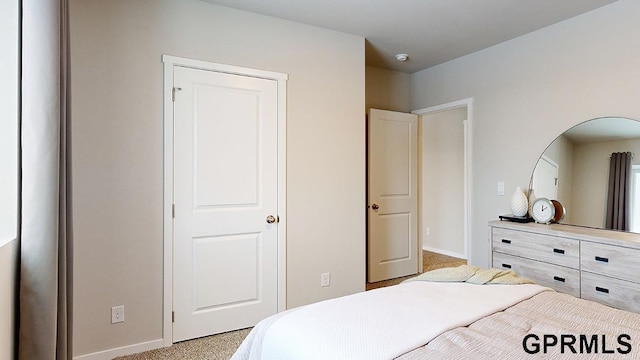 bedroom featuring light colored carpet