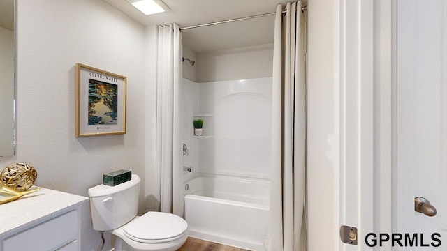 full bathroom featuring wood-type flooring, shower / washtub combination, vanity, and toilet