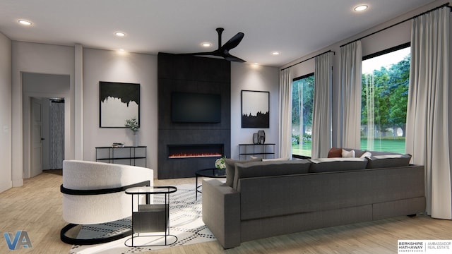 living room with ceiling fan, a fireplace, and light hardwood / wood-style flooring