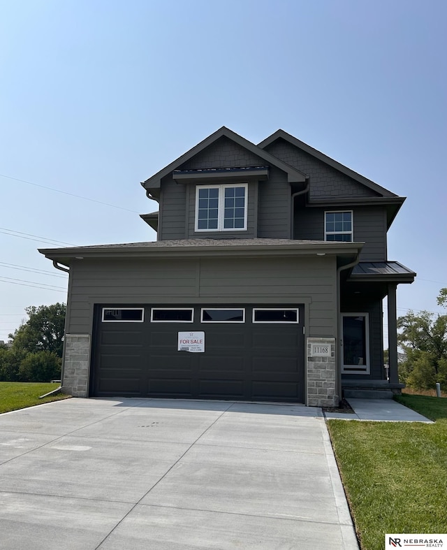 view of front of home with a garage and a front yard