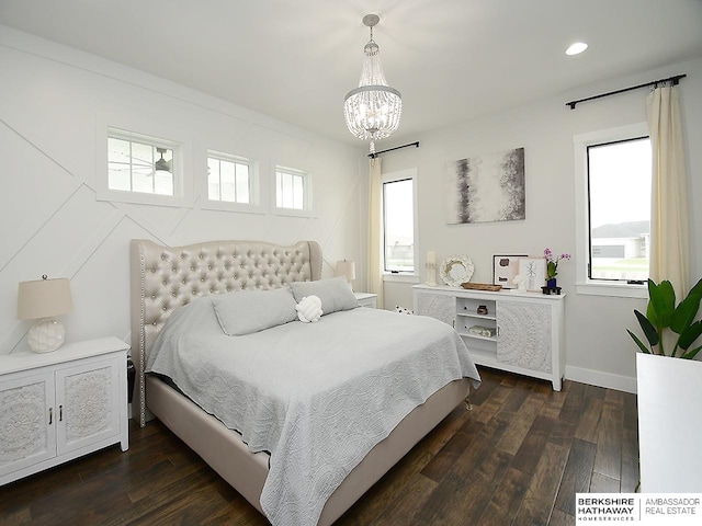 bedroom with multiple windows, an inviting chandelier, and dark hardwood / wood-style flooring