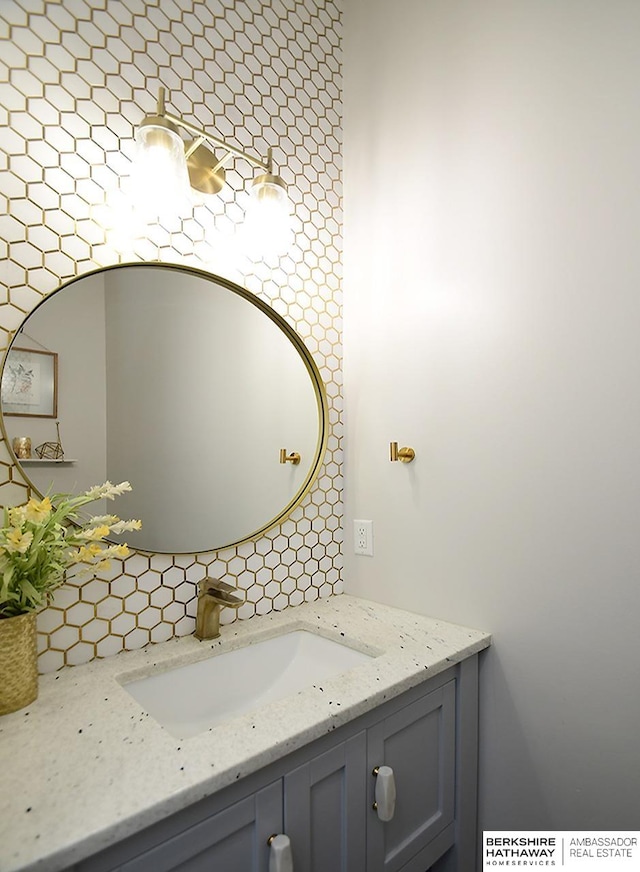 bathroom featuring vanity and decorative backsplash