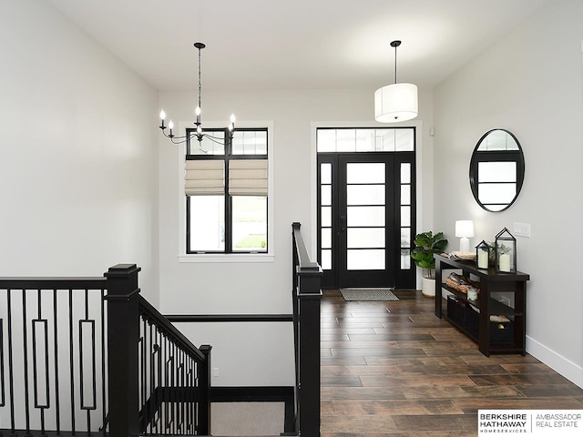 entrance foyer with a notable chandelier and dark hardwood / wood-style floors