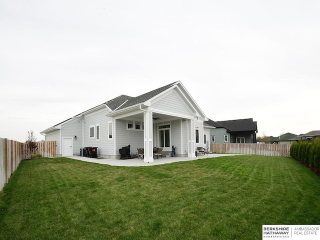 back of house featuring a yard and a patio area