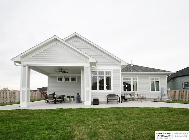 rear view of property with a patio, ceiling fan, and a yard