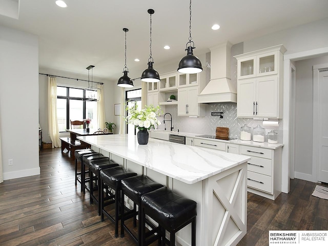 kitchen featuring white cabinetry, a large island, custom exhaust hood, and dark wood-type flooring