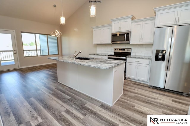 kitchen with white cabinets, appliances with stainless steel finishes, hanging light fixtures, and sink