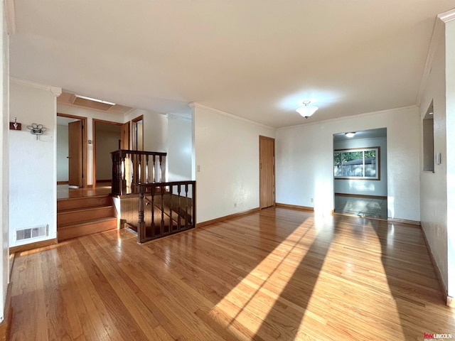 empty room with wood-type flooring and ornamental molding