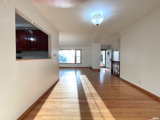 hallway with light hardwood / wood-style floors and crown molding