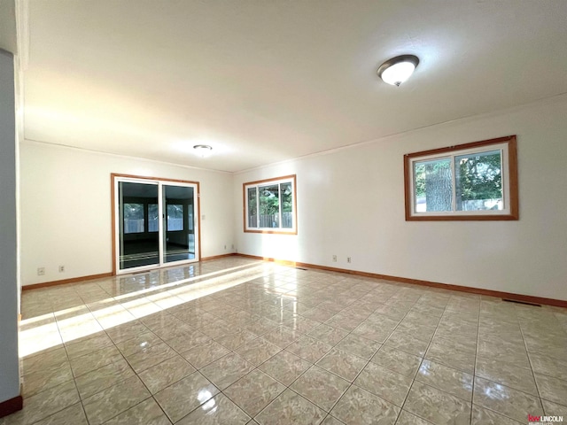 unfurnished room featuring crown molding