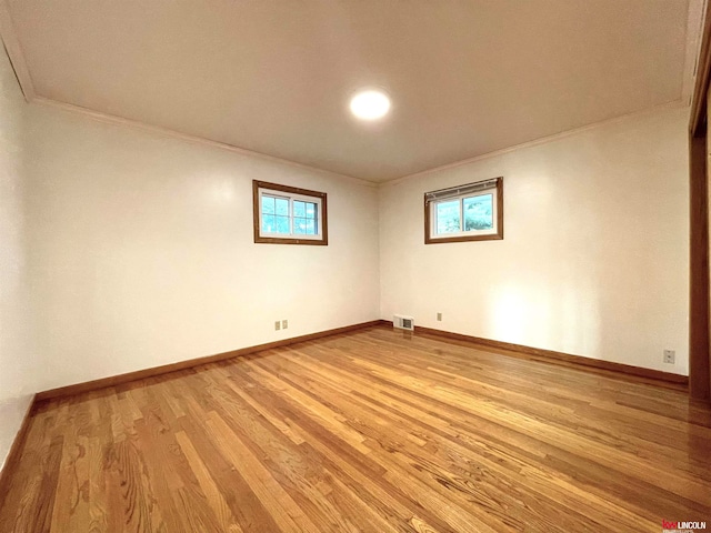 unfurnished room with ornamental molding and light hardwood / wood-style floors