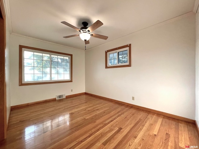 unfurnished room featuring ornamental molding, ceiling fan, and light hardwood / wood-style flooring