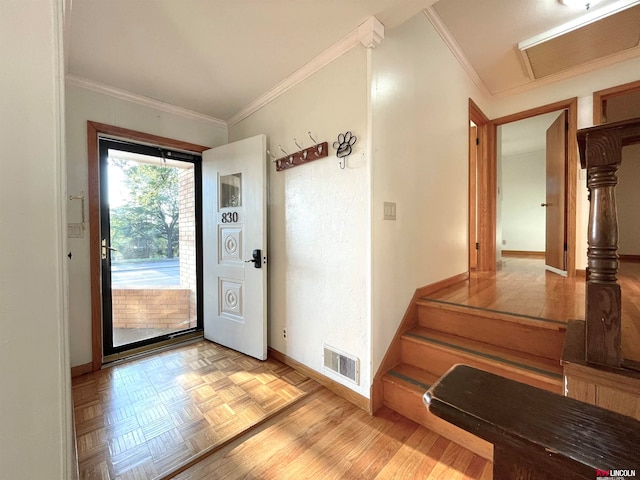 doorway to outside with light parquet flooring and ornamental molding