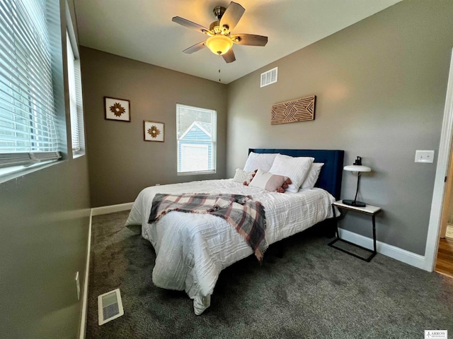 bedroom featuring ceiling fan and dark carpet