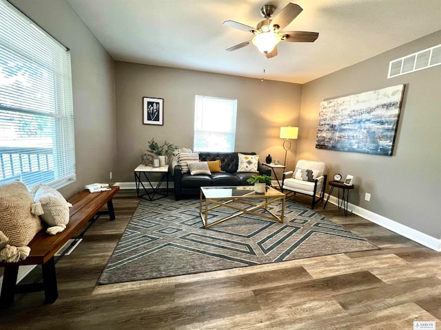 living room with ceiling fan and dark hardwood / wood-style floors