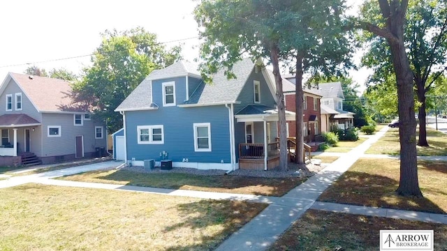 view of property exterior with a lawn, cooling unit, and a porch