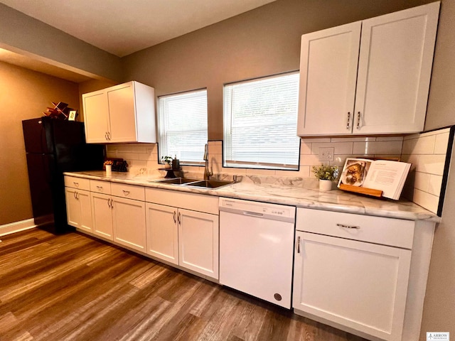 kitchen with dishwasher, dark hardwood / wood-style floors, black fridge, sink, and white cabinets