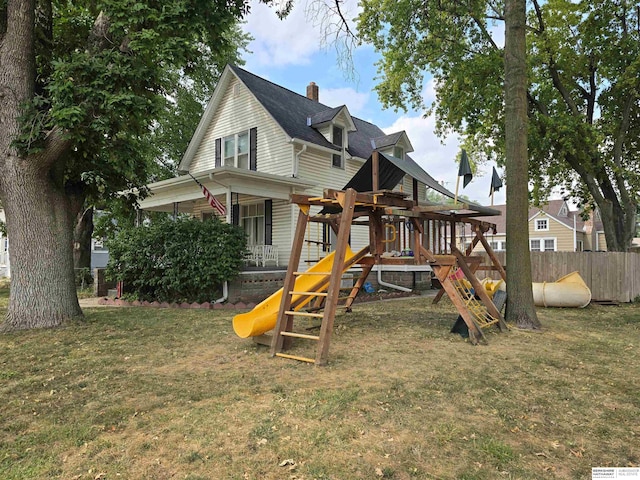 view of playground with a lawn