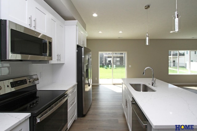 kitchen featuring a wealth of natural light, sink, pendant lighting, and appliances with stainless steel finishes