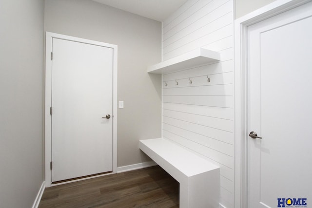 mudroom featuring wood walls and dark wood-type flooring