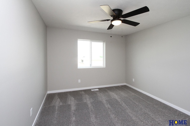 unfurnished room with dark colored carpet and ceiling fan