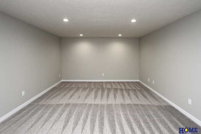 carpeted spare room featuring a textured ceiling