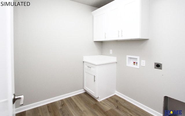 washroom featuring cabinets, hookup for a washing machine, dark hardwood / wood-style flooring, and electric dryer hookup