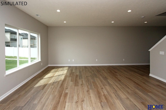 empty room with hardwood / wood-style floors