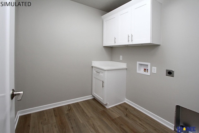 clothes washing area with hookup for an electric dryer, washer hookup, cabinets, and dark wood-type flooring