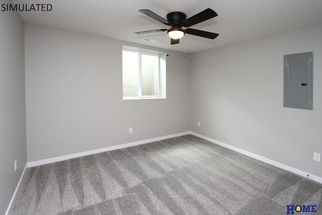 empty room with carpet flooring, ceiling fan, and electric panel