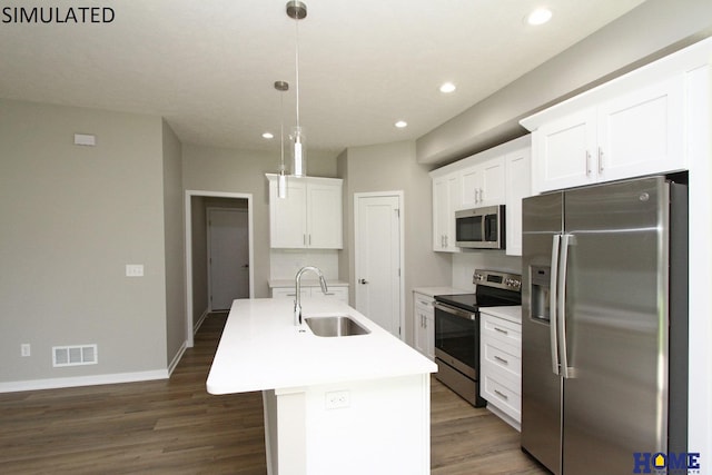 kitchen featuring white cabinetry, sink, stainless steel appliances, pendant lighting, and a kitchen island with sink