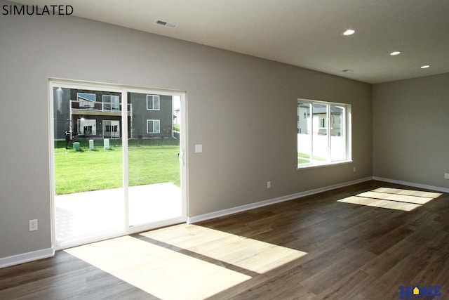 empty room with dark hardwood / wood-style flooring