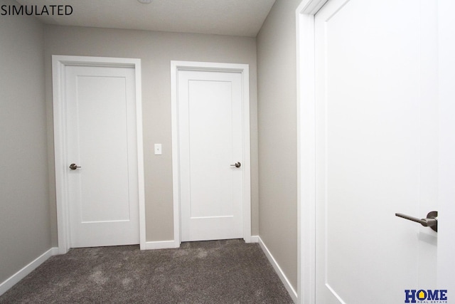 corridor featuring dark colored carpet