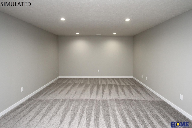 carpeted spare room featuring a textured ceiling