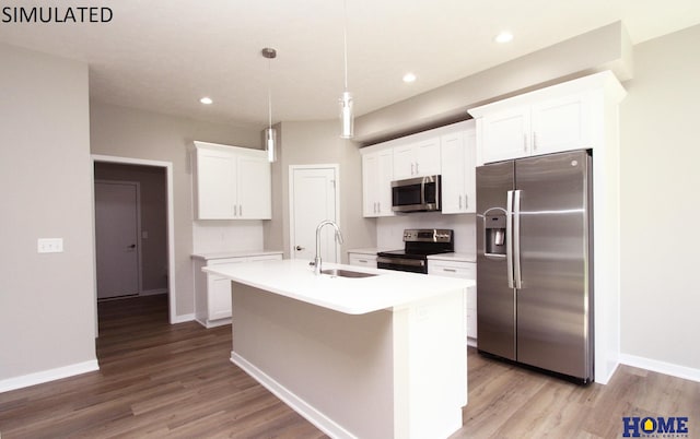 kitchen featuring pendant lighting, a kitchen island with sink, sink, white cabinetry, and stainless steel appliances