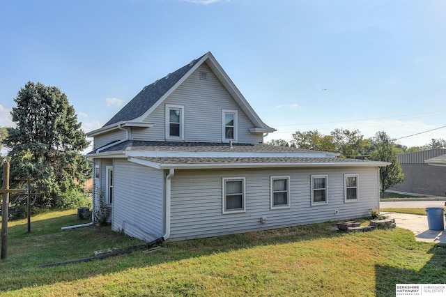 view of side of property with a lawn