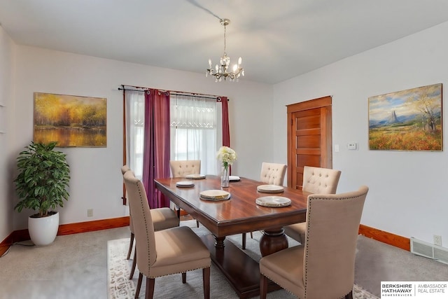 dining room featuring a chandelier and light colored carpet