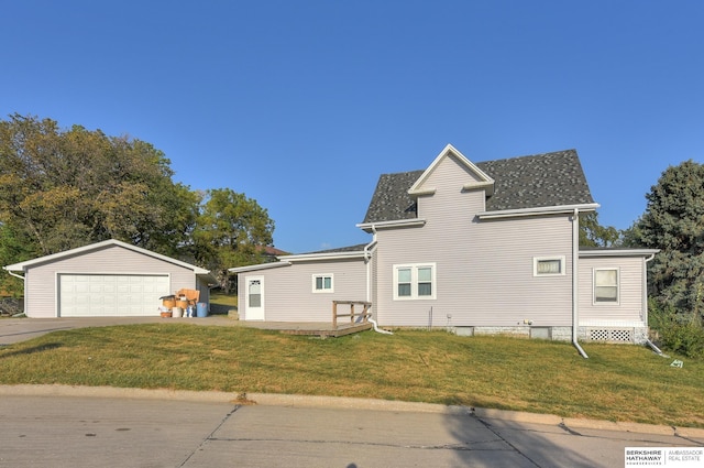 view of side of home featuring a lawn, an outdoor structure, and a garage