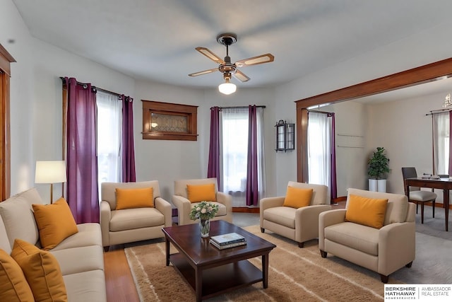 living room with light hardwood / wood-style floors and ceiling fan