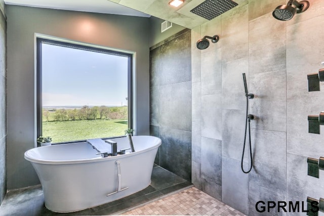 bathroom with plus walk in shower and tile patterned flooring