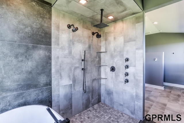 bathroom with separate shower and tub and lofted ceiling