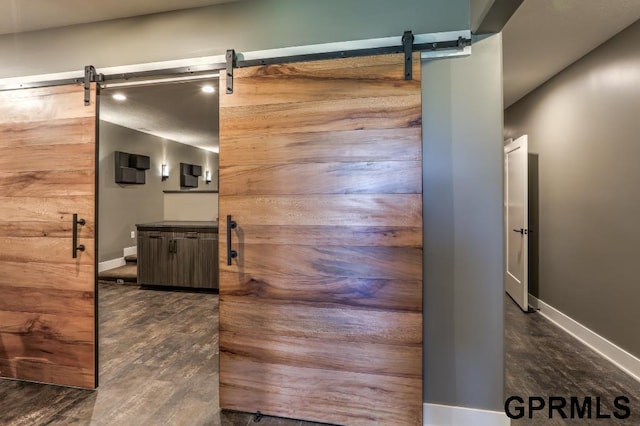 interior space featuring dark hardwood / wood-style floors and a barn door