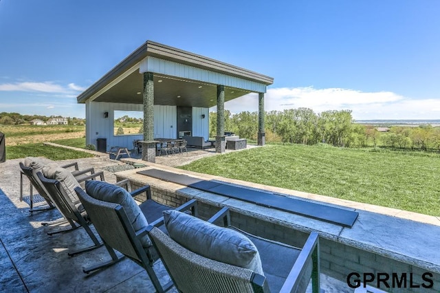 exterior space with an outdoor living space with a fire pit, a lawn, a patio, and central air condition unit