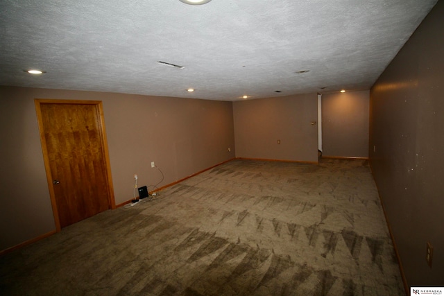 carpeted spare room featuring a textured ceiling