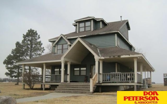 farmhouse inspired home featuring covered porch