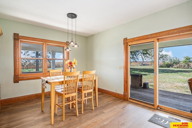 dining space featuring light wood-type flooring