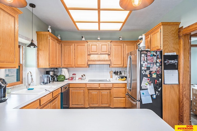 kitchen featuring appliances with stainless steel finishes, decorative backsplash, pendant lighting, custom exhaust hood, and sink