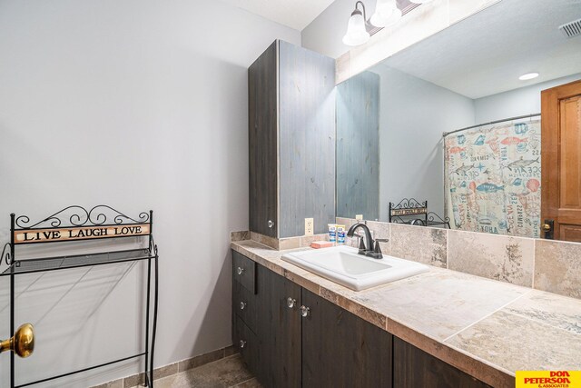 bathroom with a shower with curtain and vanity