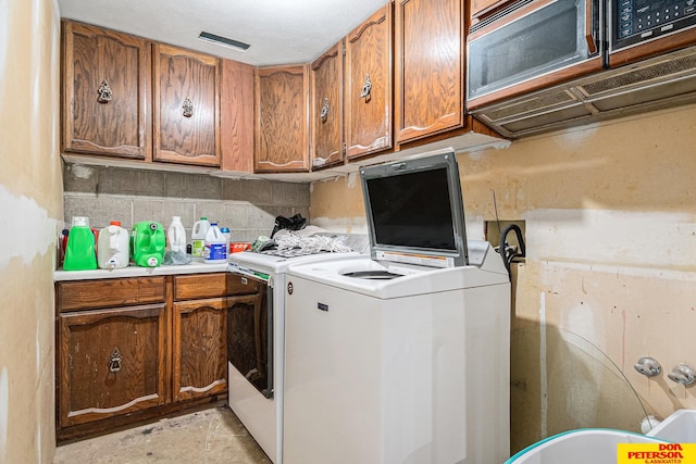 laundry area featuring cabinets and independent washer and dryer