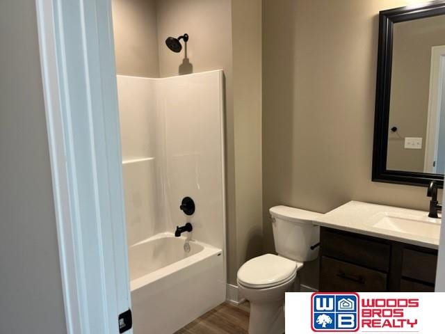 full bathroom featuring vanity, hardwood / wood-style floors,  shower combination, and toilet